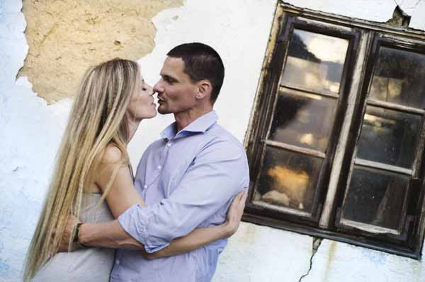 Couple in love in front of an old house