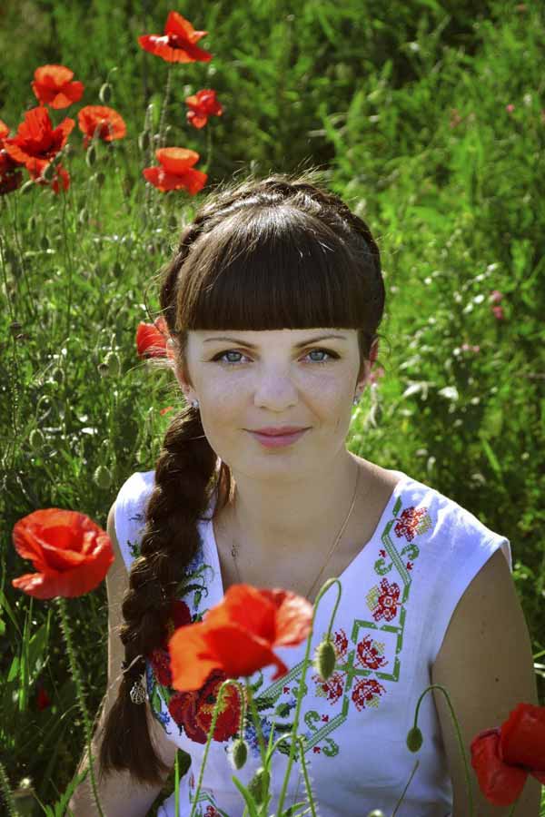 Beautiful Ukrainian woman in the fieldof flowers