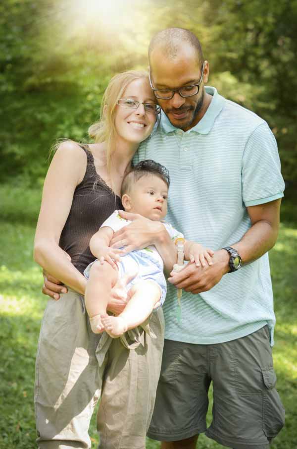 Happy interracial family is enjoying a day in the park. 