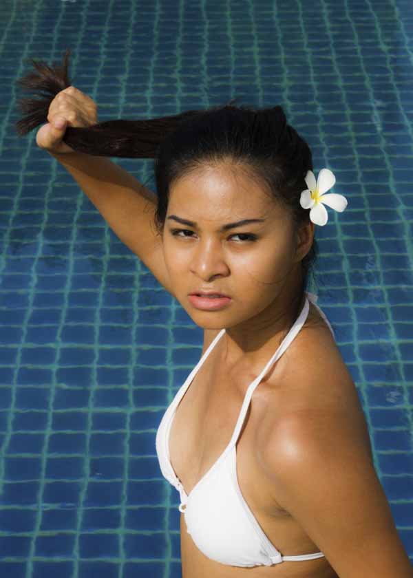 Beautiful asian girl beside the pool.