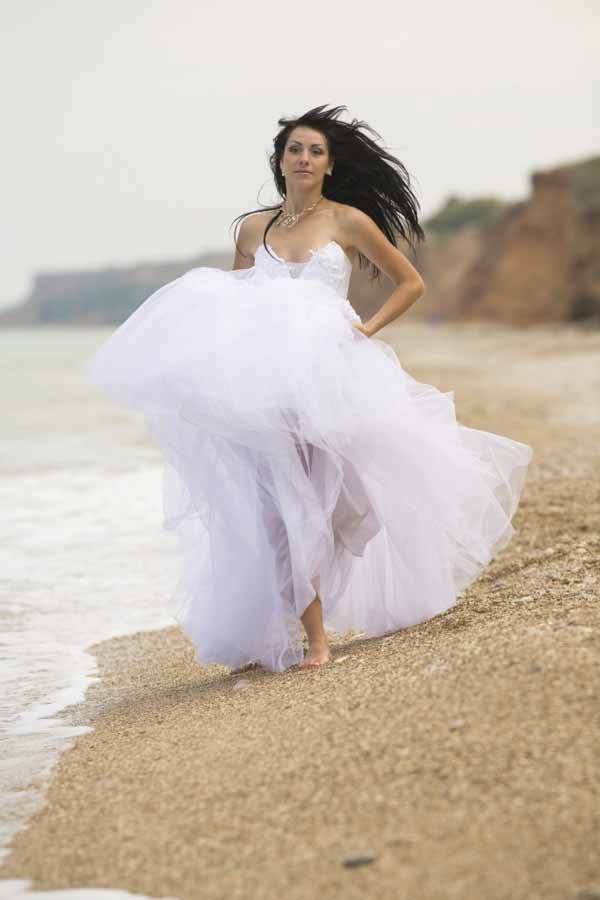 Russian Bride running on the Beach