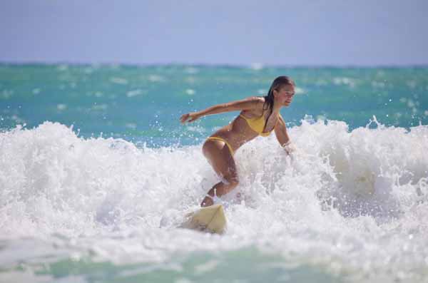 girl surfing in Hawaii