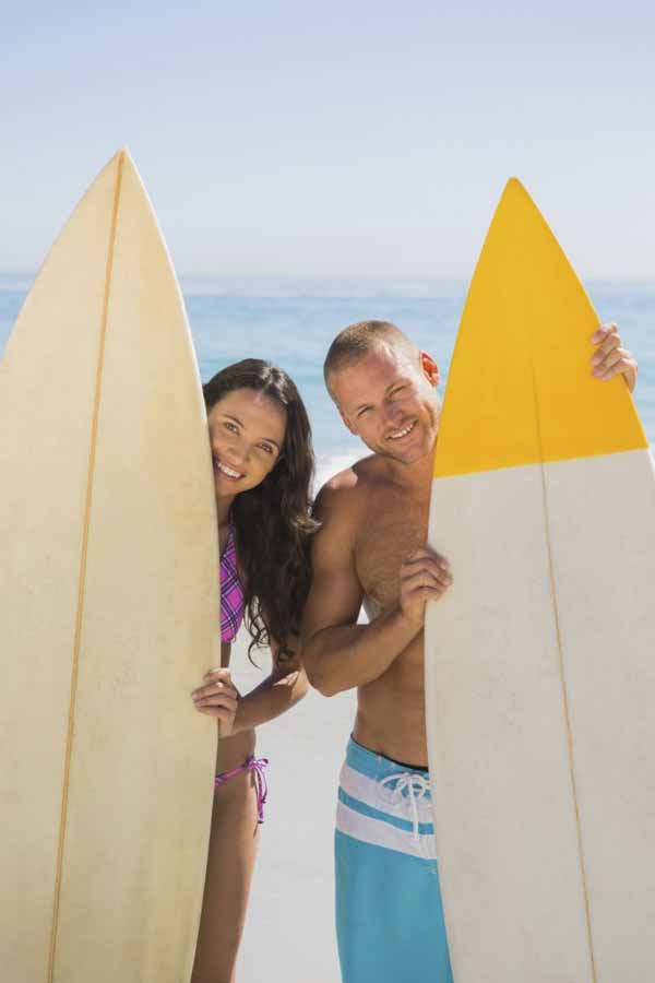 young surfer couple on the beach 