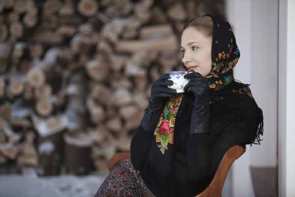 Russian woman traditional scarf with cap of tea