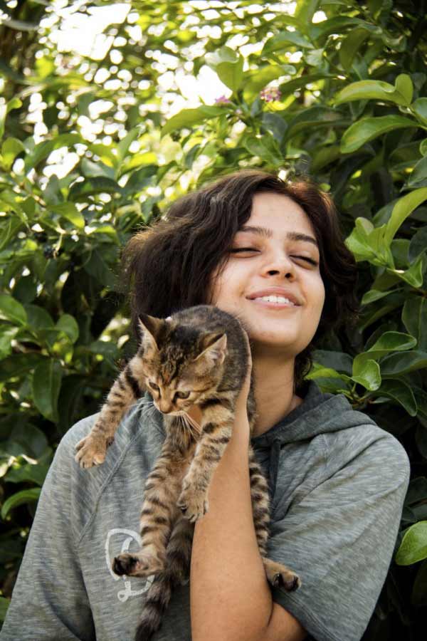 smiling girl holding cat