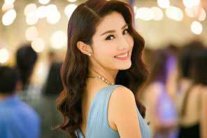 a beautiful Vietnamese girl with curly hair in a light blue dress