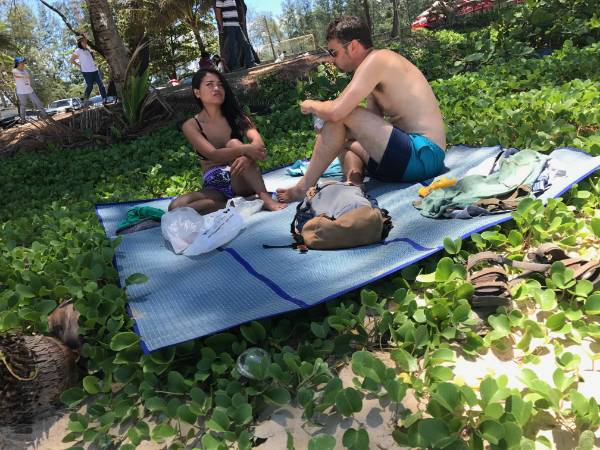 American man and Thai girl on the beach