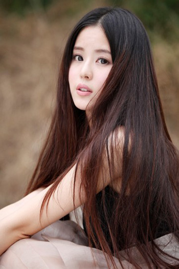 a stunning young Chinese woman with long dark brown hair 